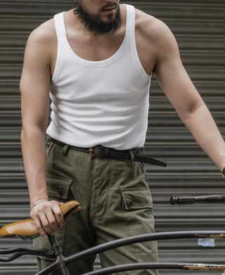 White sleeveless cotton tank top with crew neckline worn by a man