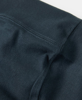 Dark vintage cotton T-shirt, close-up of side seam and stitched hem