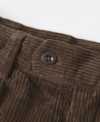 Brown corduroy trousers with round dark button on waistband
