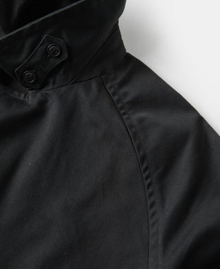 Black all-weather trench coat sleeve with cuff tab and buttoned fastening