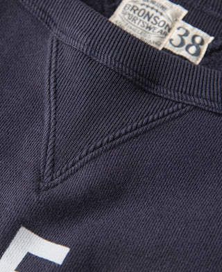 Navy sweater stitching detail near neckline and diagonal V-inset seam