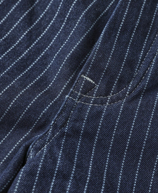 Indigo pinstripe fabric panel with curved pocket opening and contrast stitching