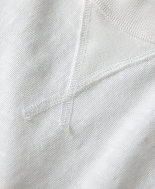 White cotton T-shirt sleeve and side seam stitching detail