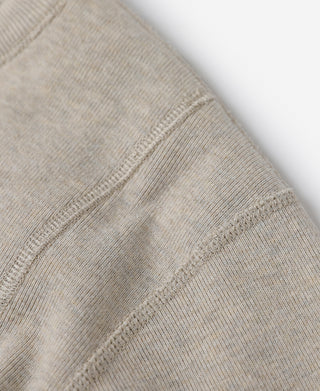 Close-up of light heather beige sleeve seam and ribbed cuff edge