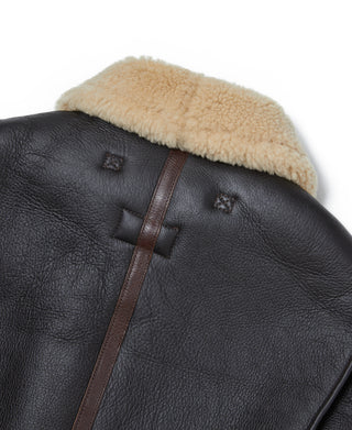 Dark leather flight jacket back yoke with cream shearling collar