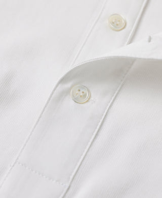 White henley shirt with button placket and curved seam detail on the chest