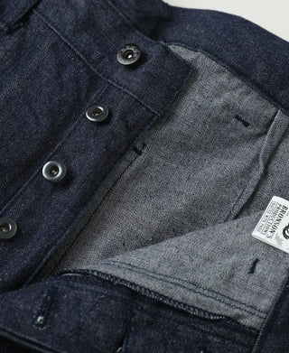 Indigo denim front with metal buttons and label at coin pocket