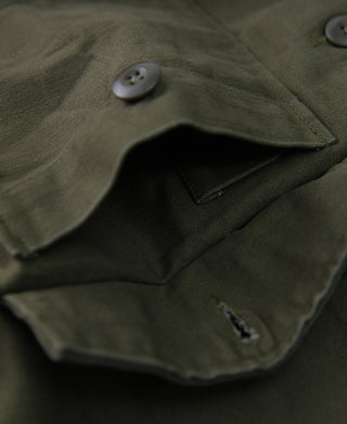 Olive fatigue utility shirt pocket and button detail with inner pocket opening