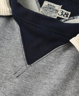 Hooded sweatshirt neckline close-up, navy yoke and gray body with BRONSON label
