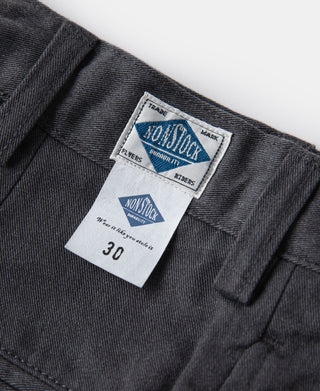 Dark gray chino trousers with Non-Iron brand label and waistband tab