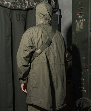 Olive parka back view with hood and shoulder strap.