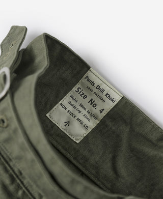 Olive pants size and fabric label inside waistband with care details