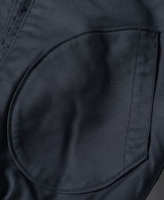 Navy deck jacket front flap pocket close-up with curved pocket outline