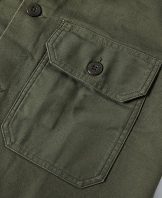 Olive fatigue utility shirt chest pocket with buttoned flap and double-stitching