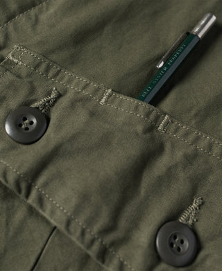 Olive jacket sleeve cuff area with button and visible stitched seams