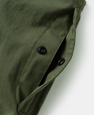 Olive trouser side button tab and welt seam with concealed opening