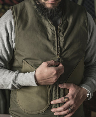 Olive pile-lined zip-front vest with metal zipper pull detail