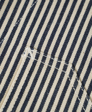 Striped vest fabric detail with stitched emblem near pocket area