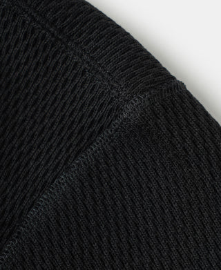 Black long-sleeve thermal shirt with waffle knit texture on sleeve