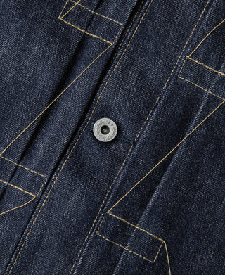 Indigo denim chest pocket with flap, metal button, and yellow contrast topstitching