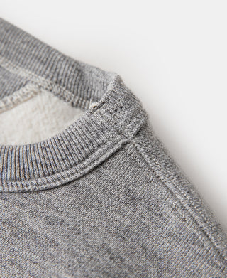 Gray sweater with ribbed V-neck collar and shoulder seam detail