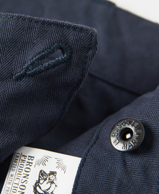 Navy utility shorts with woven texture and metal snap button, branded fabric patch