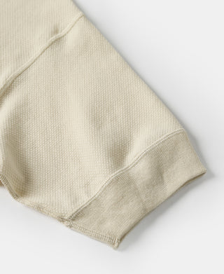 Light apricot waffle-knit sleeve and hem seam detail