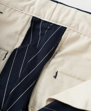 Navy pinstripe work pants with dark lining and stitched waistband