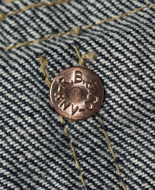 Indigo denim pocket button with engraved letters and stitched seams