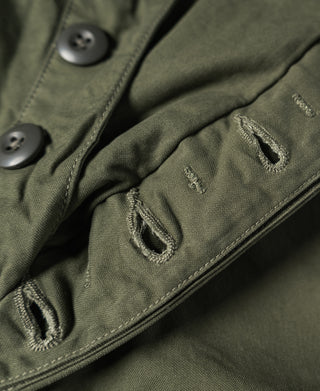 Olive cargo pants with flap pockets and metal-button front detail
