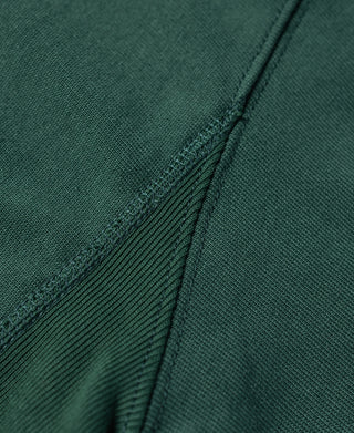 Green T-shirt side panel seam with reinforced stitching for durability.