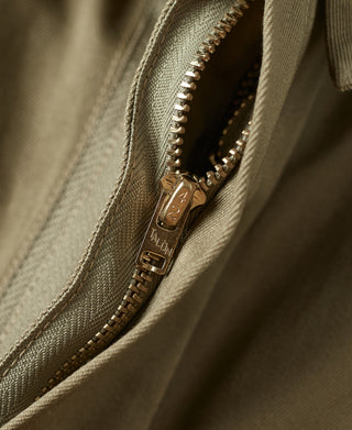 Khaki green paratrooper jacket zipper with metal pull tab and stitched edge