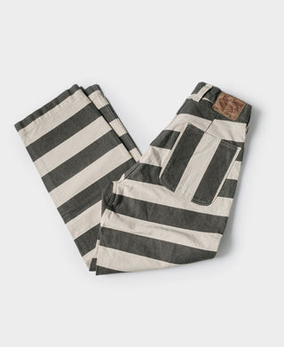 Wide striped prisoner pants folded flat, white and black horizontal stripes, wide-leg cut.