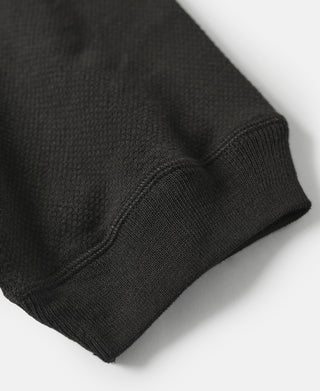Black waffle-knit sleeve hem and stitched seam detail