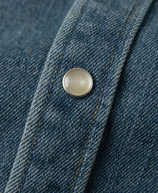 Blue denim western shirt sleeve placket with round metal snap button