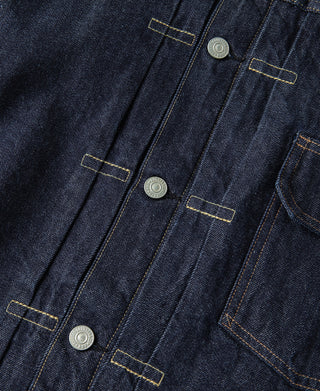 Indigo denim jacket front placket with row of round metal snaps and yellow stitching
