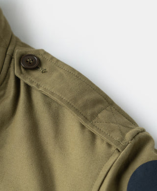 Khaki flight jacket sleeve cuff with dark button closure and stitched placket detail.