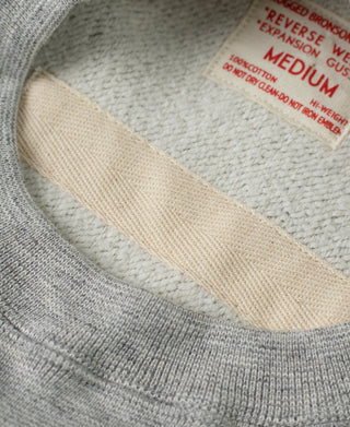 Gray sweatshirt neck label and cream-colored interior facing