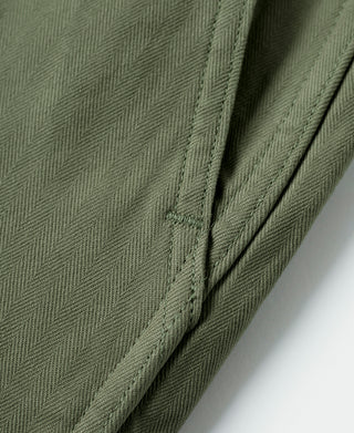 Olive HBT twill fabric close-up with fine diagonal weave and side seam