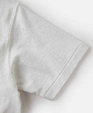 White tubular athletic t-shirt sleeve hem with clean stitched edge, close-up.