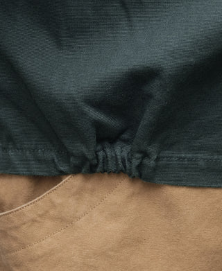 Dark green jacket hem with elastic drawstring and inner tan lining