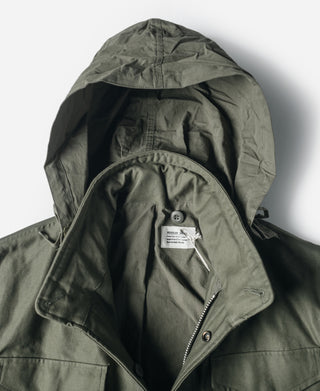 Olive field jacket hood with drawstring and interior lining detail.