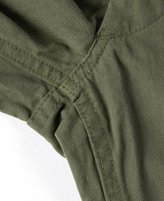 Olive fatigue pants button closure and inner waistband seam detail