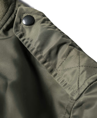 Olive L-2 flight jacket sleeve with stitched quilting detail and snap closure