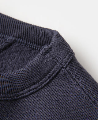Navy ribbed collar edge with V-inset seam on crewneck sweater