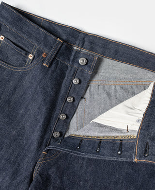 Dark blue denim jeans interior view of the button placket and waistband with pocket lining