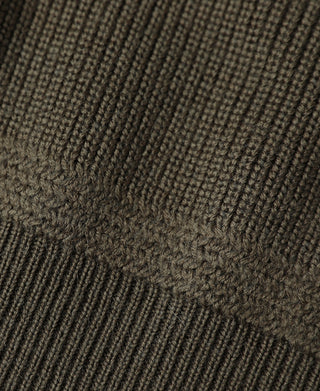 Olive wool sweater knit texture close-up with ribbed pattern