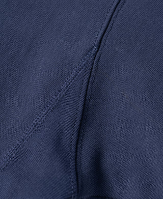 Navy T-shirt side seam close-up with stitched panel and woven texture