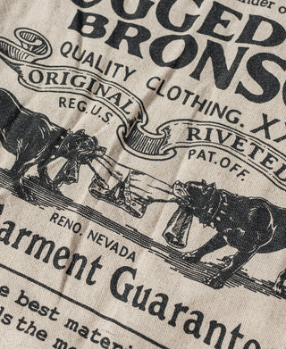 Natural linen tote bag close-up of vintage-style printed graphic and lettering.