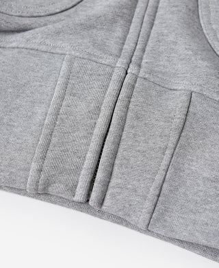Gray terry cloth hoodie hem and pocket seam details, full-zip style